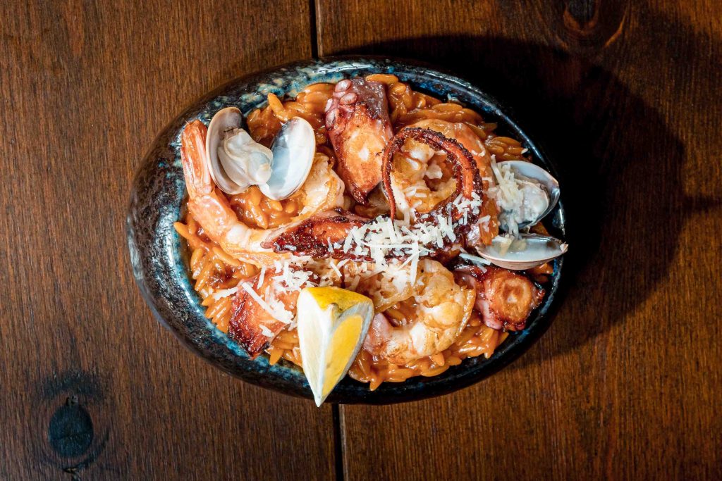 Seafood Kritharoto with orzo pasta, prawns, octopus, clams and parmesan